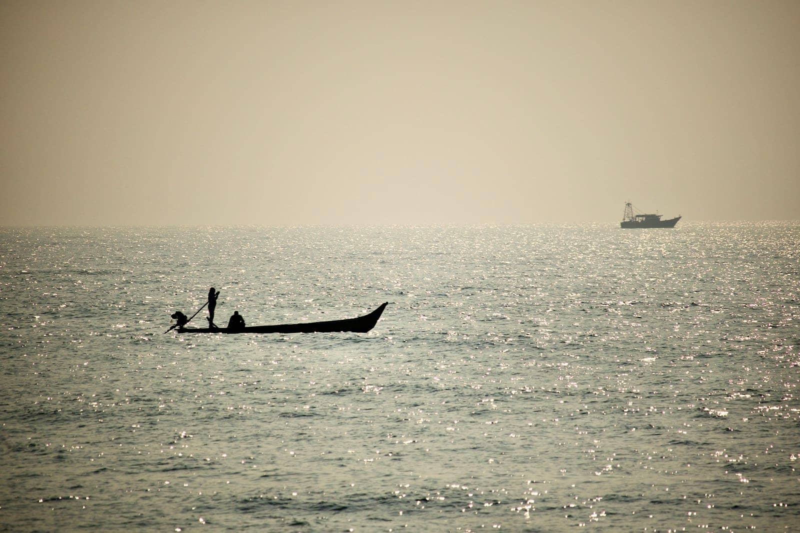 Fishermen silhouetted against the sea at first light